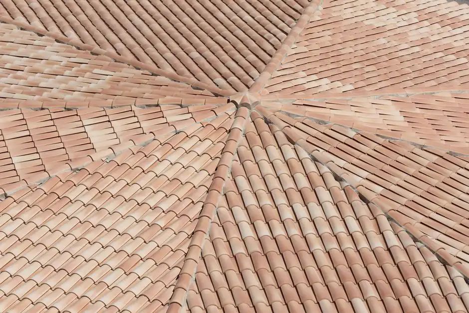 Detailed view of terracotta roof shingles forming a geometric pattern from above.