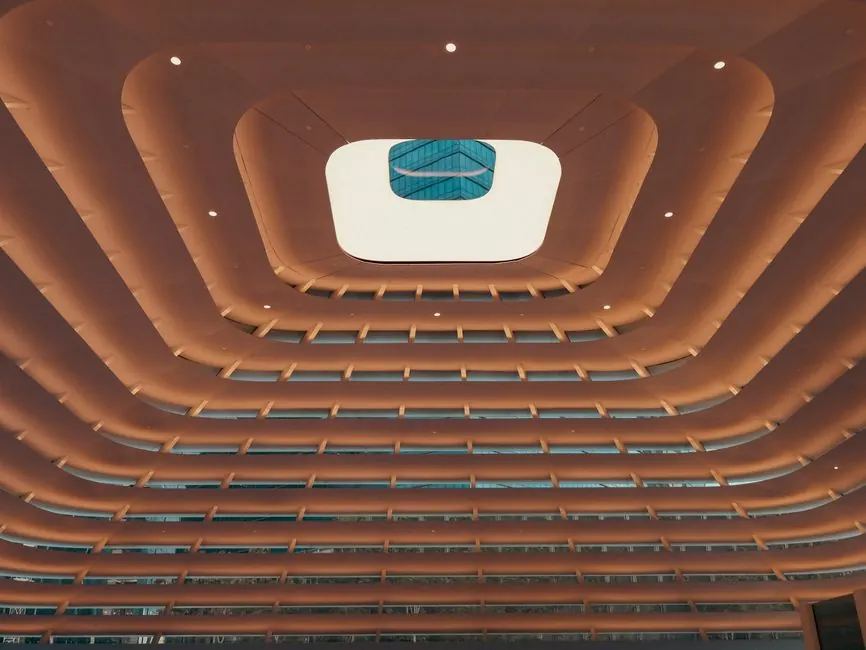 Intricate ceiling design with skylight in modern architecture.